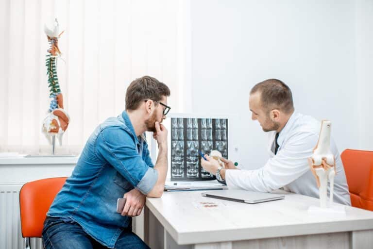 Man in psychiatrist's office, getting both therapy and psychiatry
